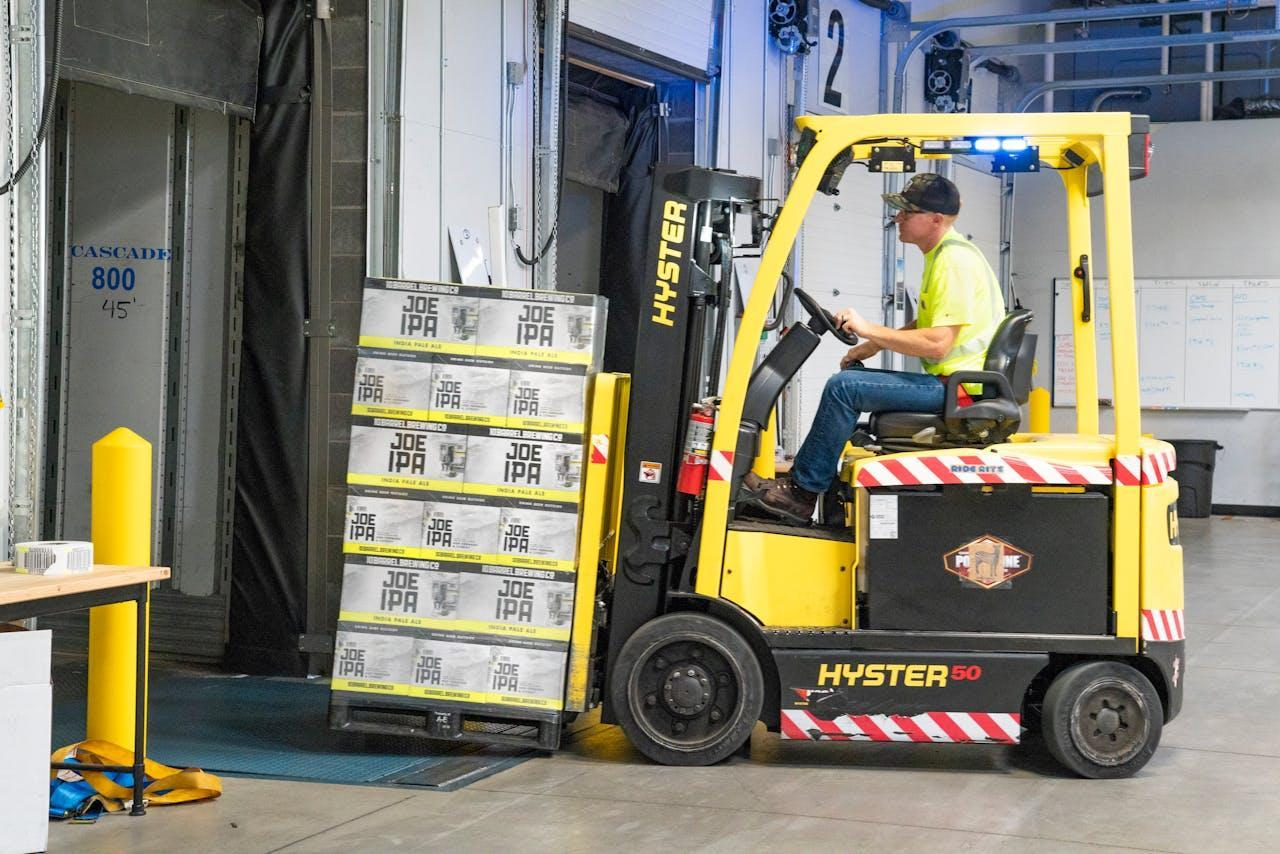 Man riding a yellow forklift